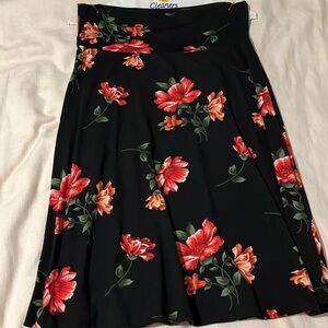 Black skirt with red and green floral detail. Soft and a line.